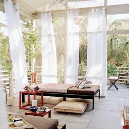 Curtain flowing in breeze on poolside
